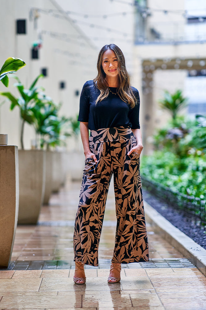 Woman wearing black and brown pants.