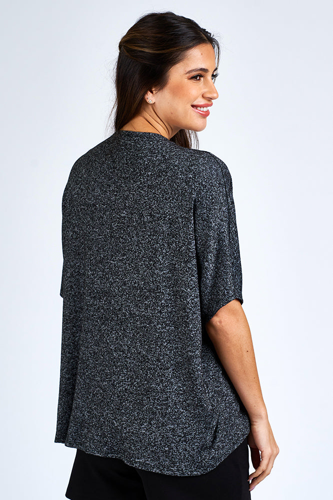 Woman wearing grey cardigan.