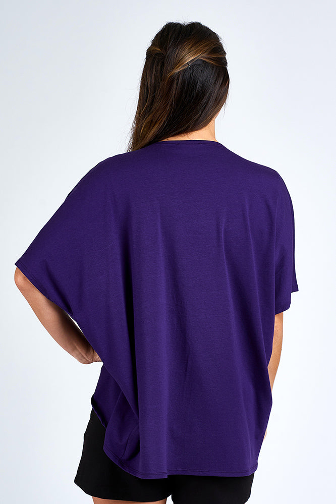 Woman wearing purple cardigan.