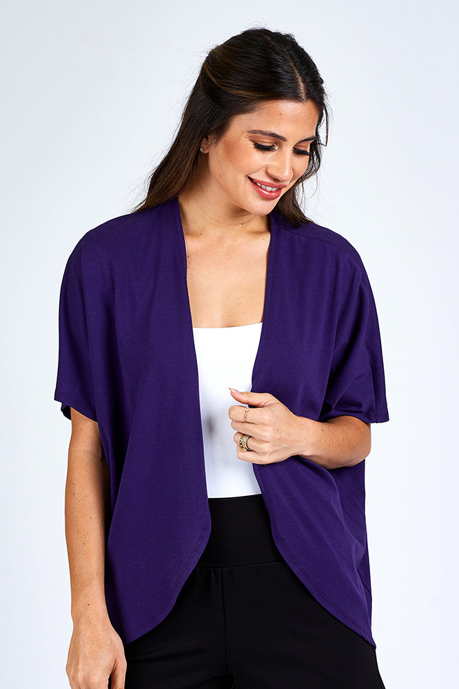 Woman wearing purple cardigan.