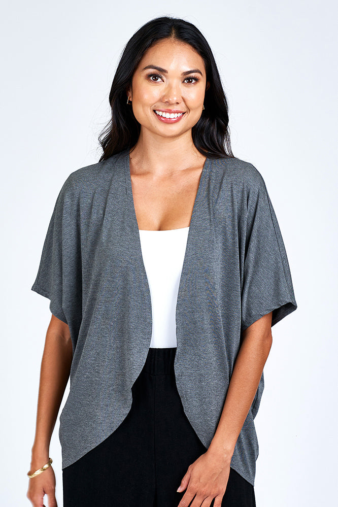 Woman wearing grey cardigan.