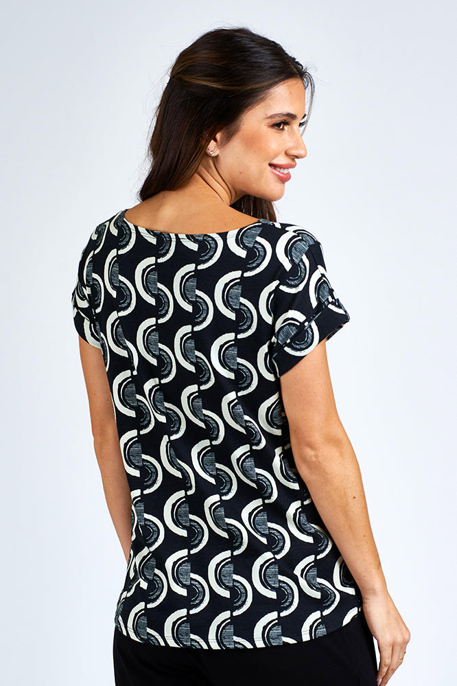 Woman wearing black and white short sleeve top.