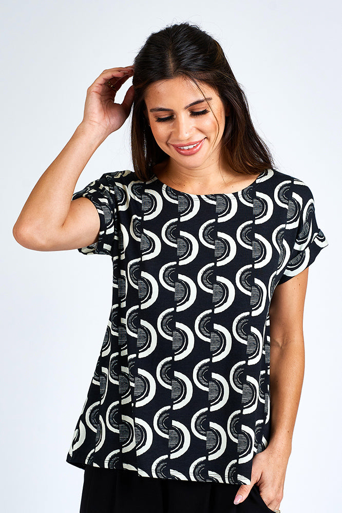 Woman wearing black and white short sleeve top.
