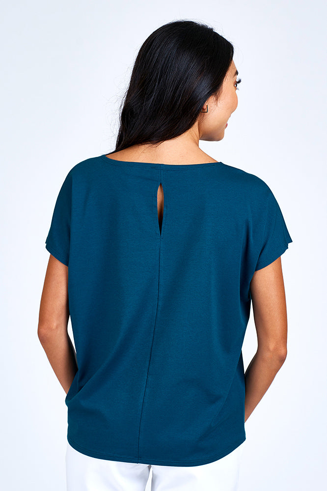 Woman wearing blue short sleeve top.