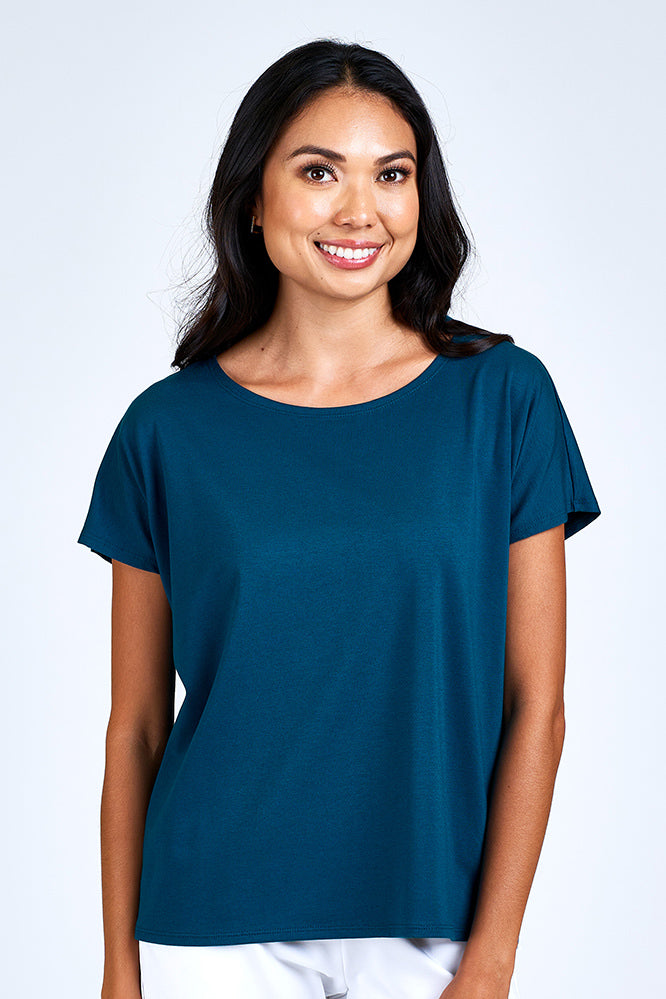 Woman wearing blue short sleeve top.