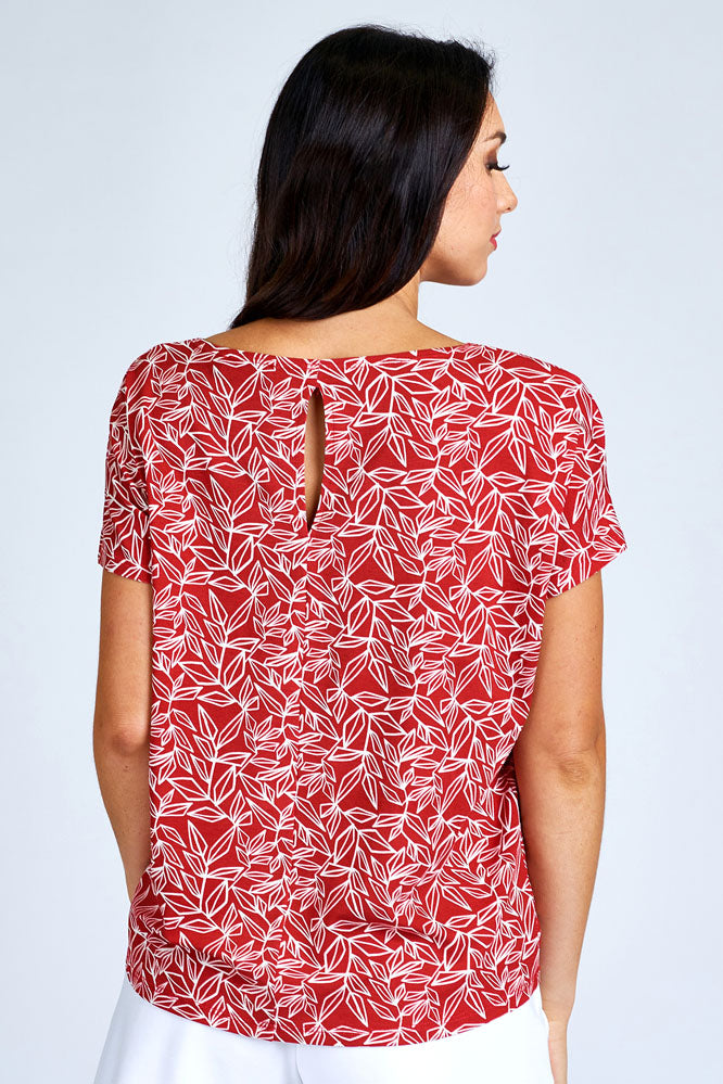 Woman wearing red and white short sleeve top.