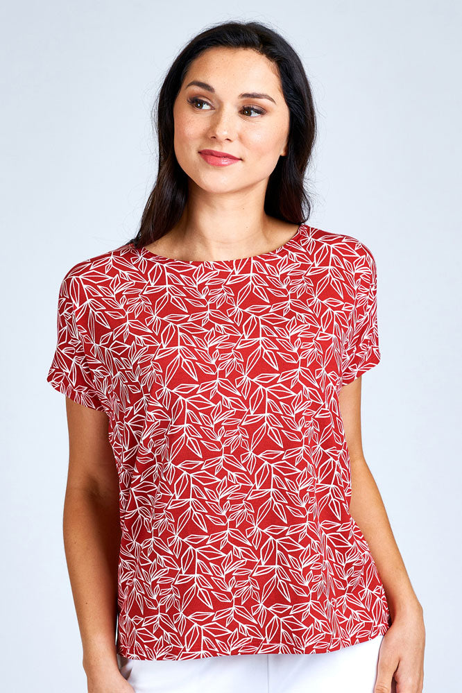 Woman wearing red and white short sleeve top.