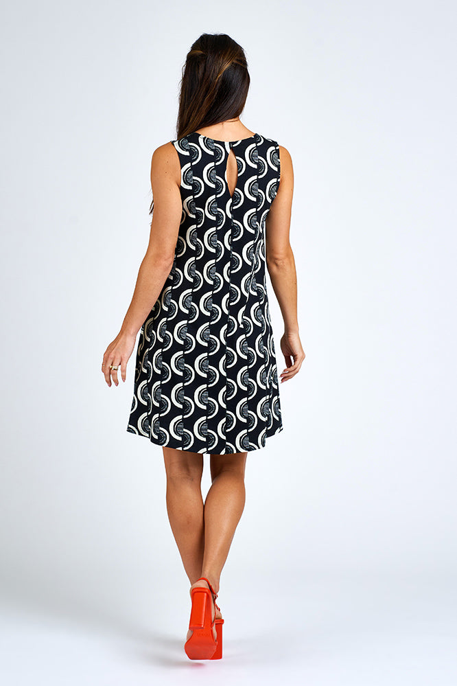 Woman wearing above knee black and white dress.