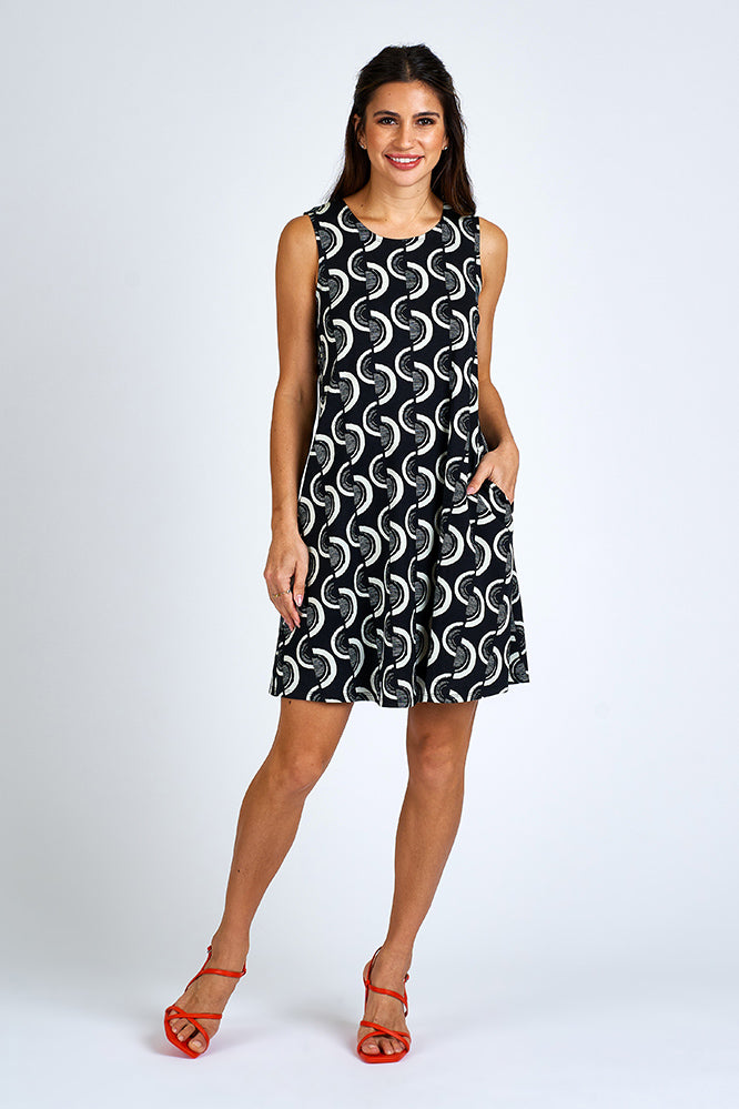 Woman wearing above knee black and white dress.