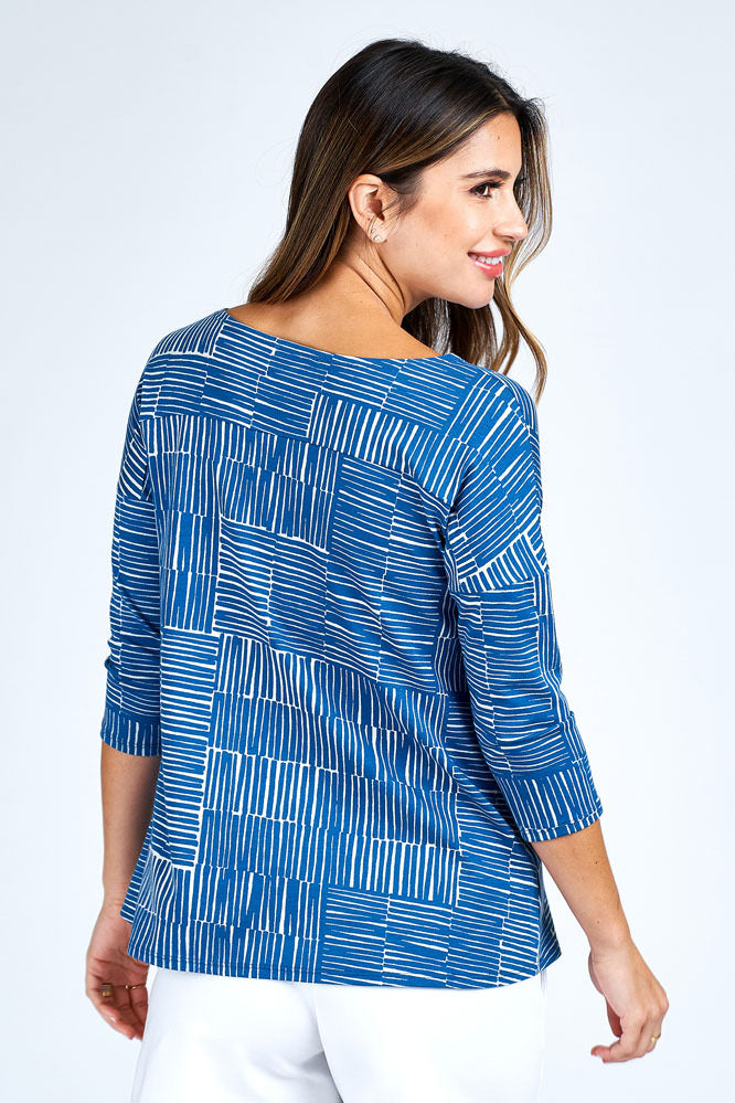 Woman wearing blue and white 3/4 sleeve top.
