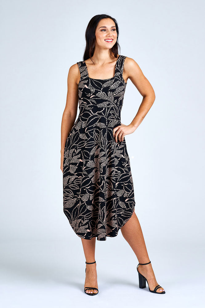 Woman wearing black and cream long dress.