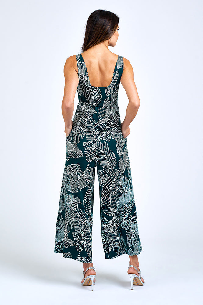 Woman wearing forest green jumpsuit.