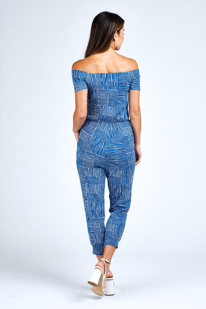 Woman wearing blue and white jumpsuit.
