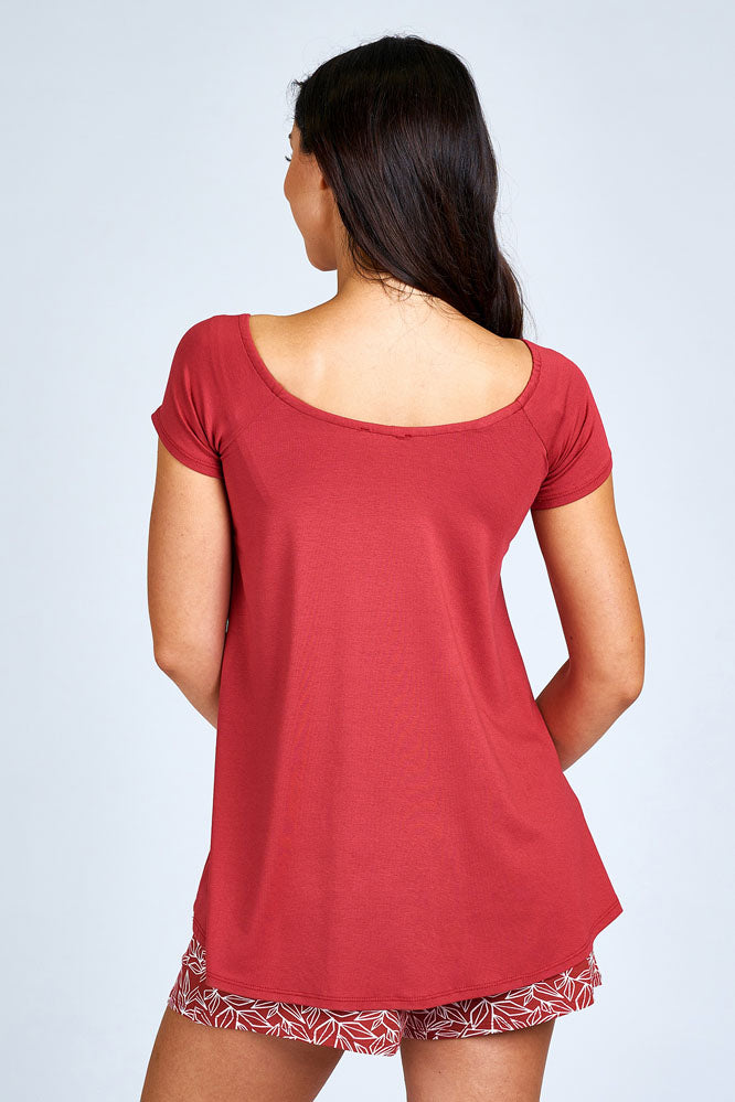 Woman wearing red short sleeve shirt.