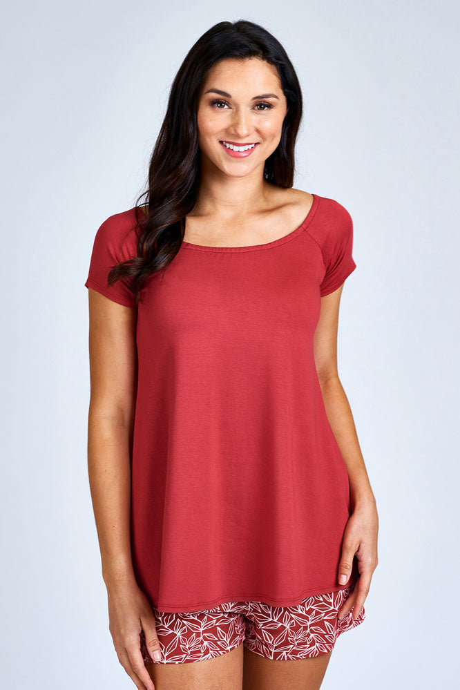 Woman wearing red short sleeve shirt.