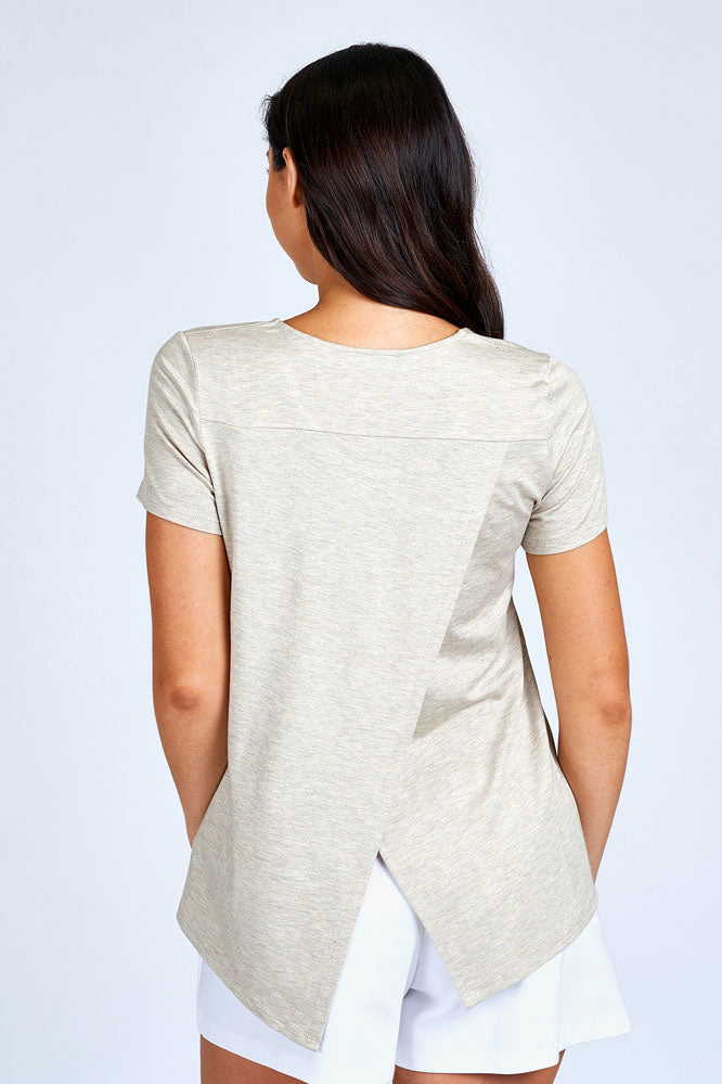 Woman wearing cream short sleeve top.