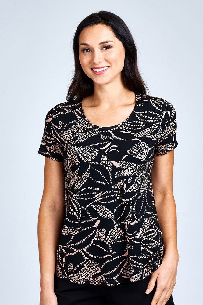Woman wearing black and cream short sleeve top.