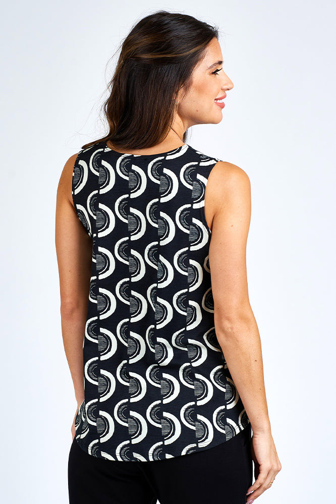 Woman wearing black and white tank top.