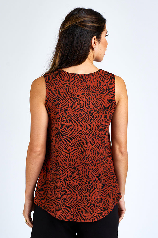 Woman wearing orange and black tank top.