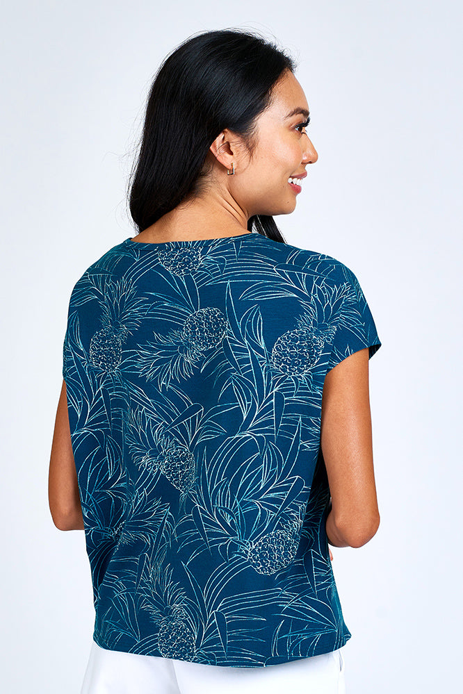 Woman wearing blue and white short sleeve top.