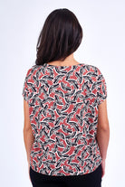 Woman wearing pink print top.
