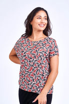Woman wearing pink print top.