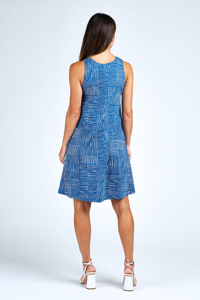 Woman wearing above knee blue and white dress.