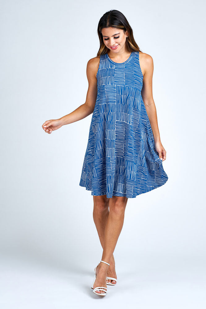 Woman wearing above knee blue and white dress.