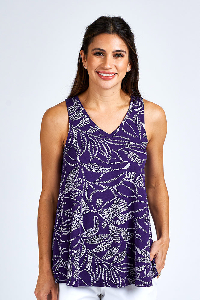Woman wearing a purple and white tank top.