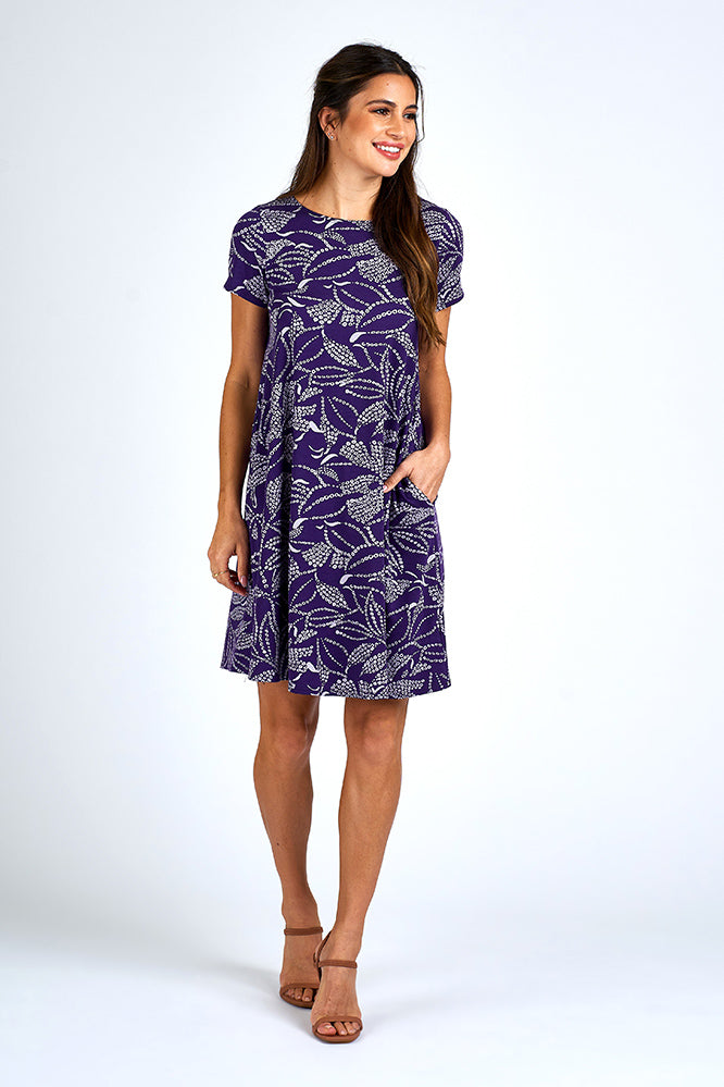 Woman wearing above knee purple and white dress.