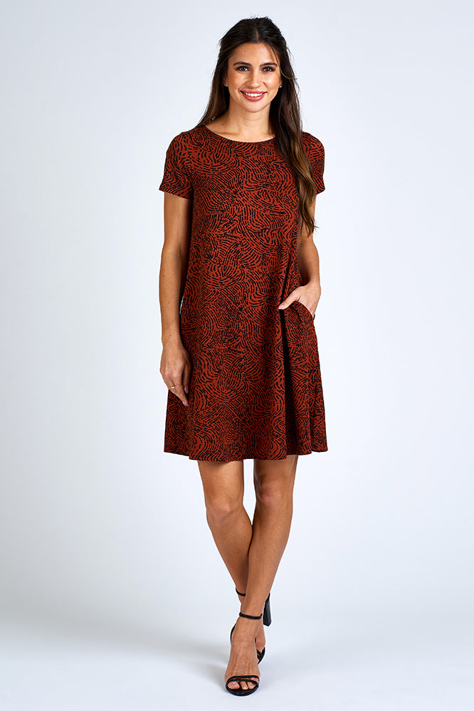 Woman wearing above knee black and orange dress.