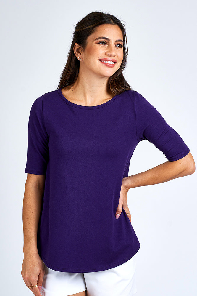 Woman wearing purple elbow sleeve length top.