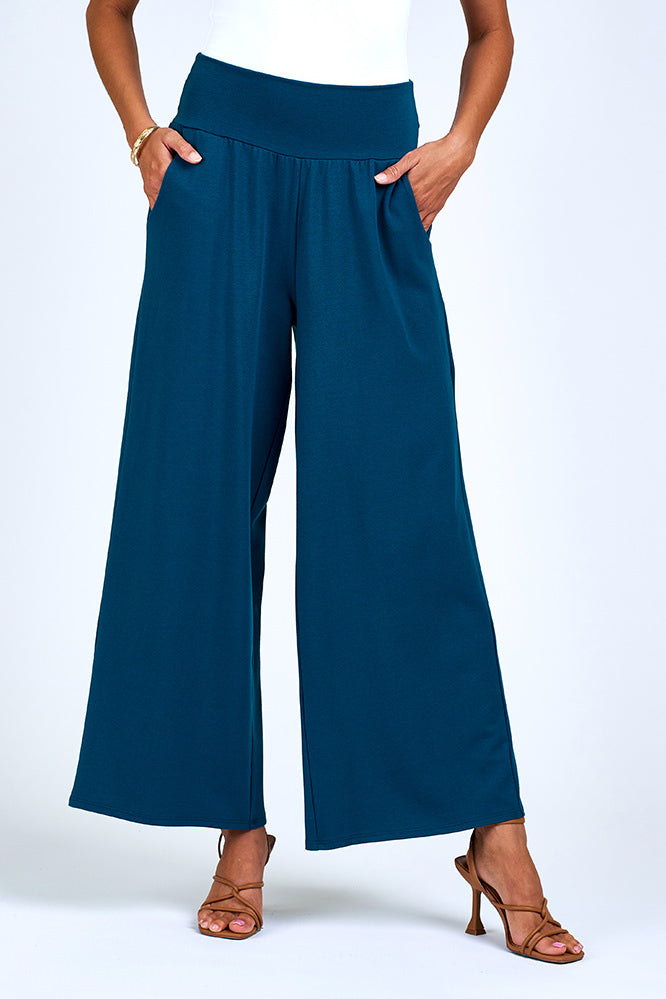Woman wearing blue wide leg pant.