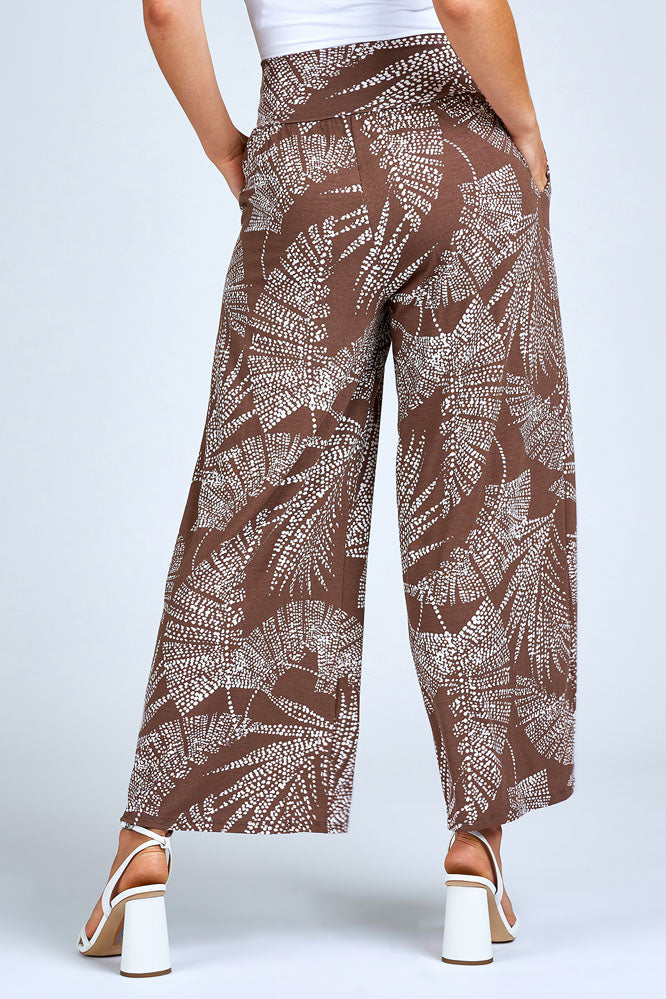 Woman wearing brown and cream wide leg pants.