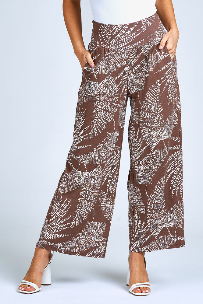 Woman wearing brown and cream wide leg pants.