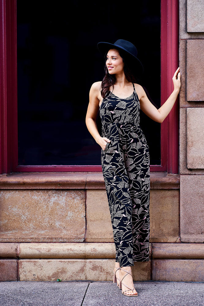Woman wearing black and cream jumpsuit.