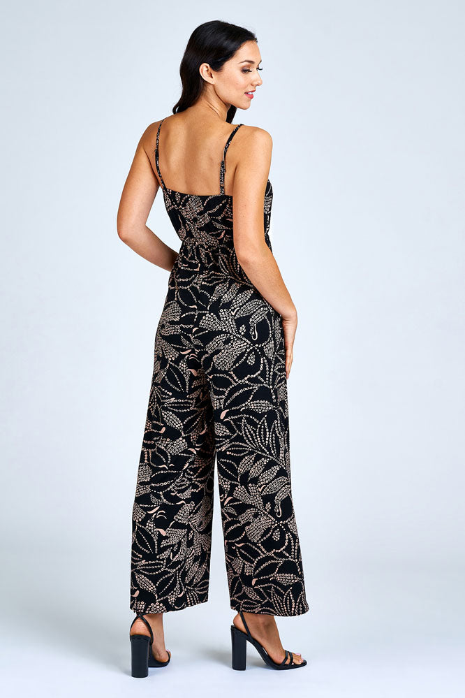 Woman wearing black and cream jumpsuit.