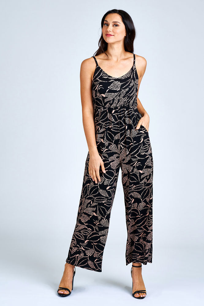 Woman wearing black and cream jumpsuit.