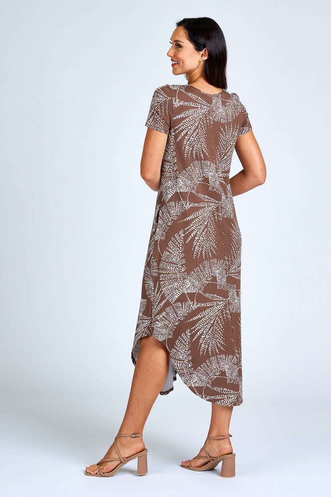Woman wearing brown and cream maxi dress.