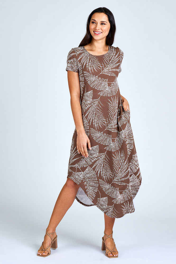 Woman wearing brown and cream maxi dress.