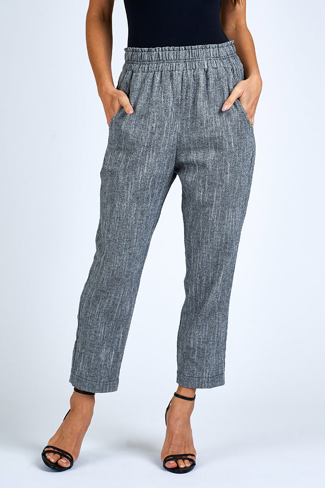 Woman wearing grey pants.