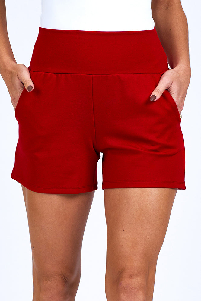 Woman wearing red shorts.