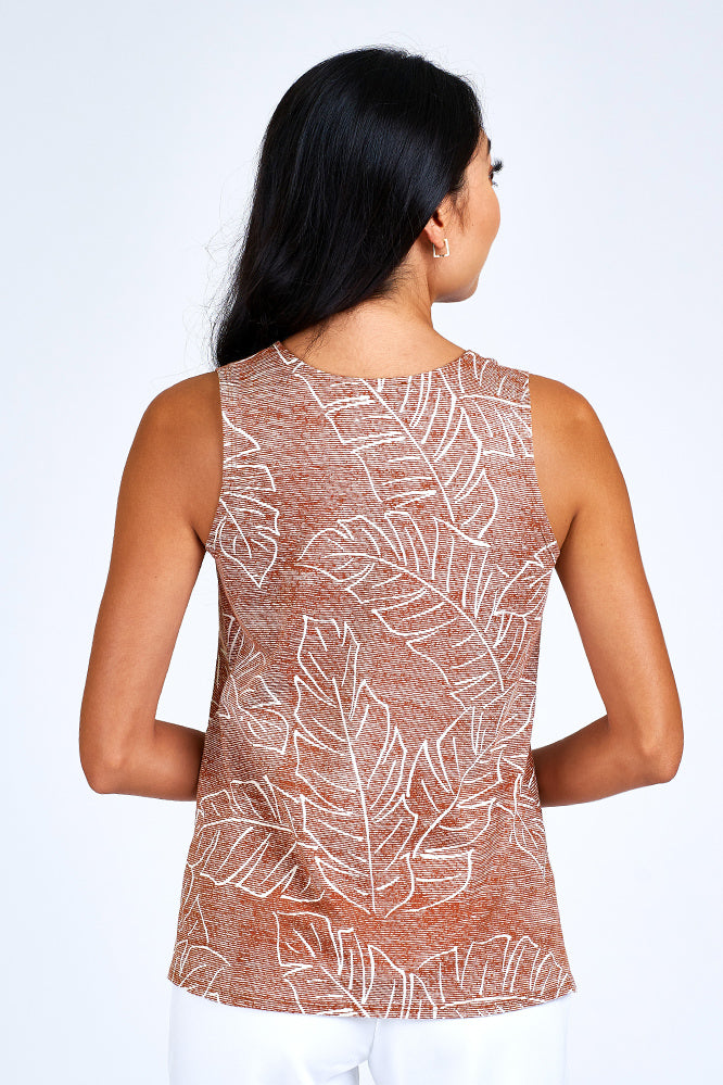 Woman wearing rust and white tank top.
