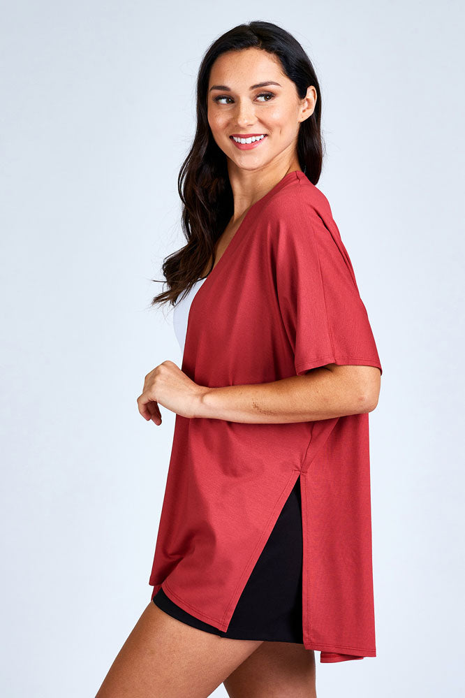 Woman wearing red cardigan.