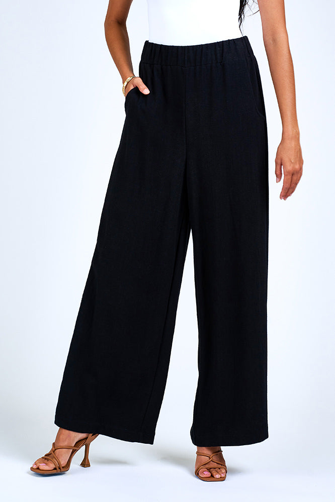 Woman wearing black wide leg pant.