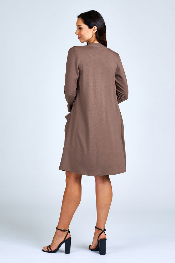 Woman wearing light brown long cardigan.