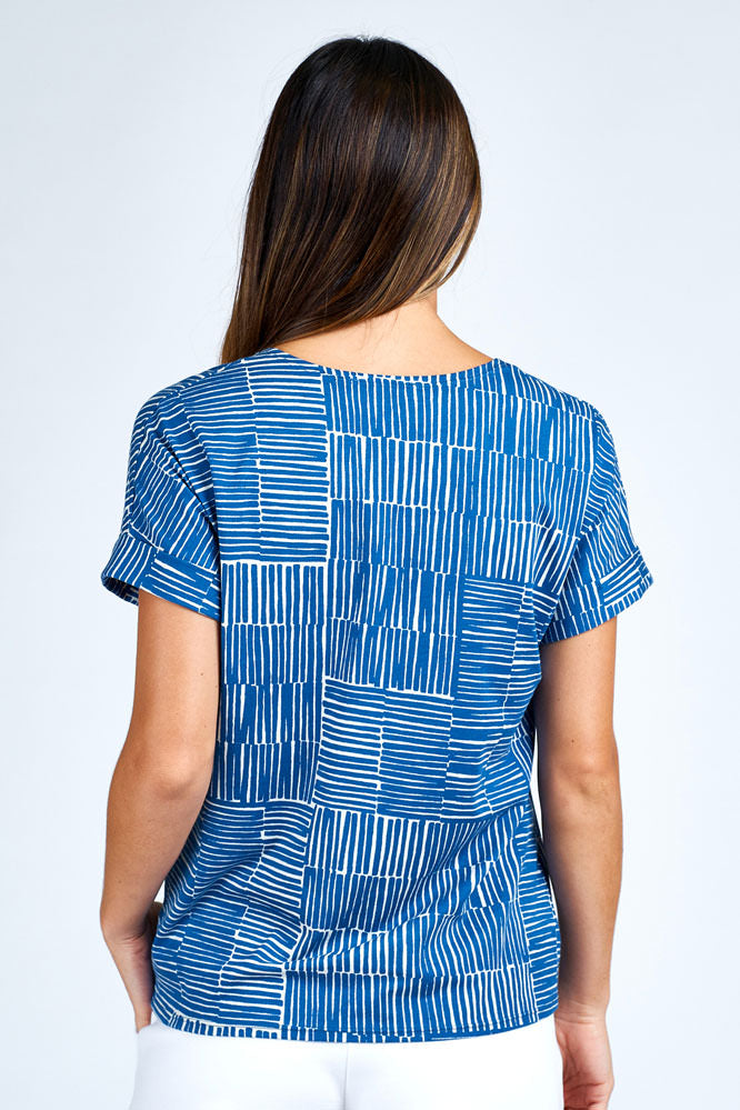 - Woman wearing blue and white short sleeve top.
