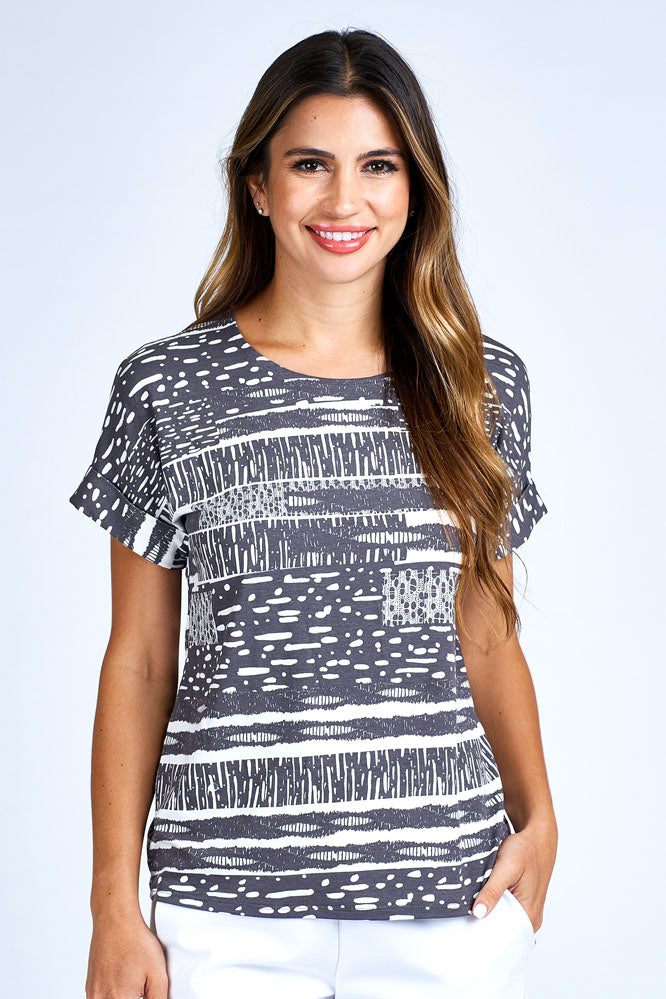Woman wearing grey and white short sleeve top.