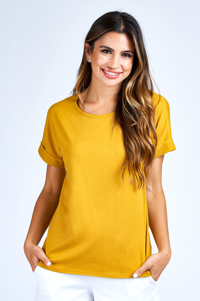 Woman wearing yellow short sleeve top.