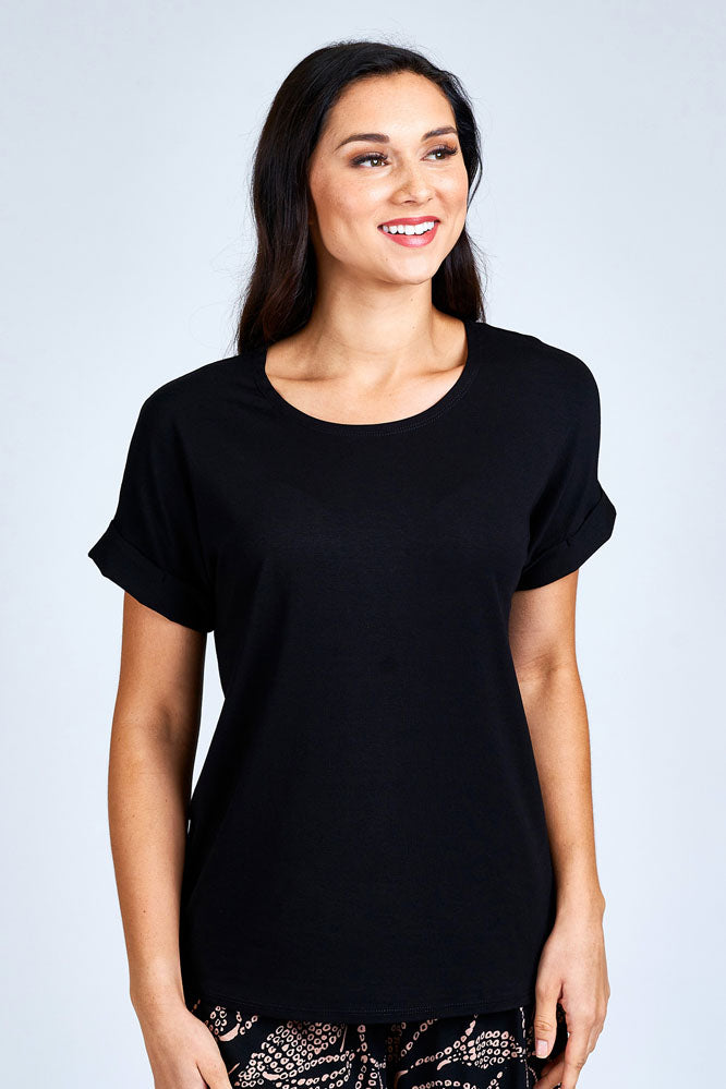Woman wearing black short sleeve top.